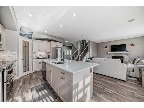 184 West Creek Boulevard, Chestermere, AB - Indoor Photo Showing Kitchen With Fireplace