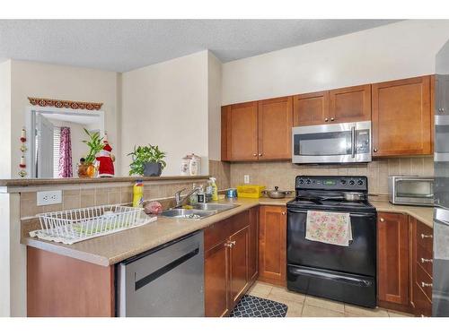 1115-1140 Taradale Drive Ne, Calgary, AB - Indoor Photo Showing Kitchen With Double Sink