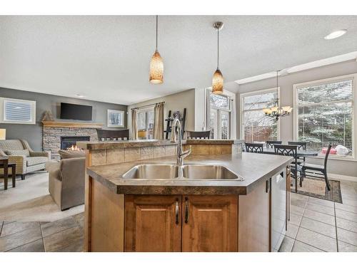 258 Cranfield Gardens Se, Calgary, AB - Indoor Photo Showing Kitchen With Fireplace With Double Sink