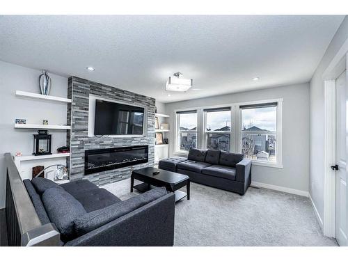 965 Midtown Avenue Sw, Airdrie, AB - Indoor Photo Showing Living Room With Fireplace