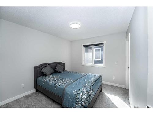 965 Midtown Avenue Sw, Airdrie, AB - Indoor Photo Showing Bedroom
