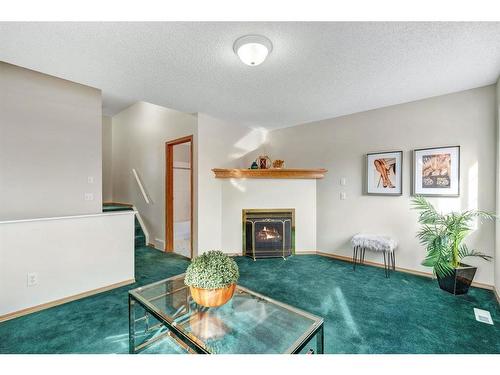 72 Mt Apex Green Se, Calgary, AB - Indoor Photo Showing Other Room With Fireplace