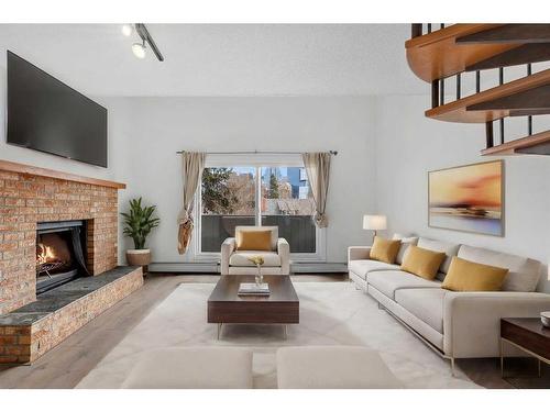 302-730 2 Avenue Nw, Calgary, AB - Indoor Photo Showing Living Room With Fireplace