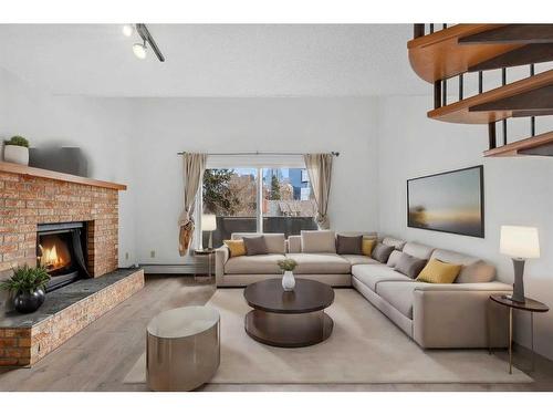 302-730 2 Avenue Nw, Calgary, AB - Indoor Photo Showing Living Room With Fireplace