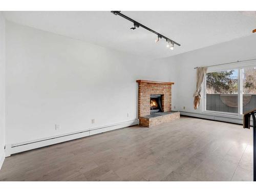 302-730 2 Avenue Nw, Calgary, AB - Indoor With Fireplace