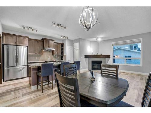 1751 Legacy Circle Se, Calgary, AB - Indoor Photo Showing Dining Room With Fireplace