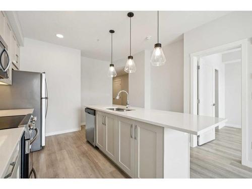 212-150 Shawnee Square Sw, Calgary, AB - Indoor Photo Showing Kitchen With Double Sink With Upgraded Kitchen