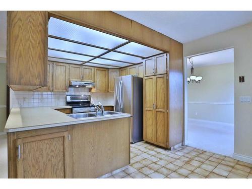 28 Hawkridge Court Nw, Calgary, AB - Indoor Photo Showing Kitchen With Double Sink