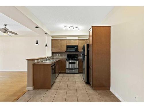 410-208 Holy Cross Sw, Calgary, AB - Indoor Photo Showing Kitchen With Double Sink