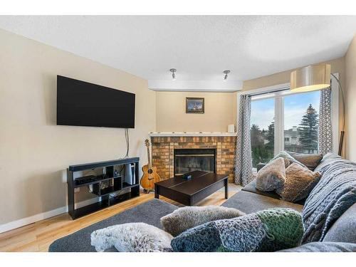 10 Coachway Gardens Sw, Calgary, AB - Indoor Photo Showing Living Room With Fireplace