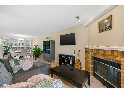 10 Coachway Gardens Sw, Calgary, AB - Indoor Photo Showing Living Room With Fireplace