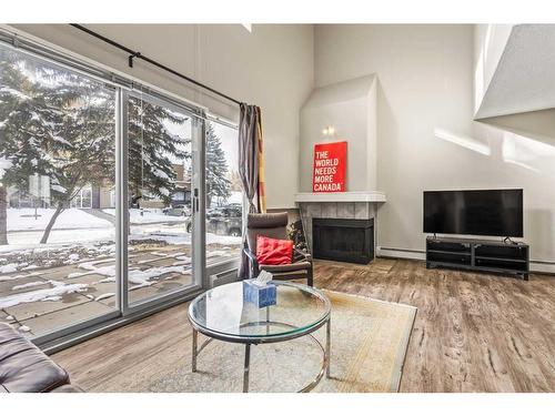 8-122 Village Heights Sw, Calgary, AB - Indoor Photo Showing Living Room With Fireplace