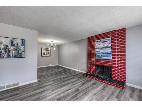 723 Cantrell Drive Sw, Calgary, AB - Indoor Photo Showing Living Room With Fireplace