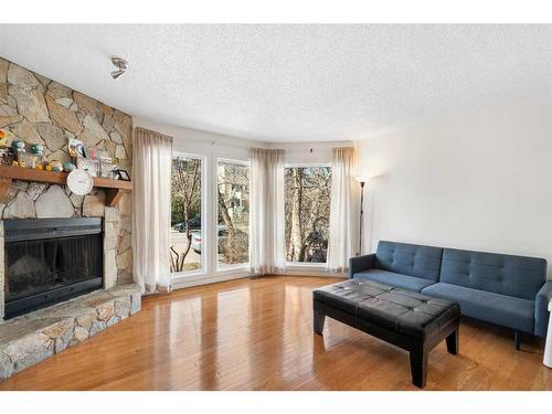 1-715 2 Avenue Nw, Calgary, AB - Indoor Photo Showing Living Room With Fireplace