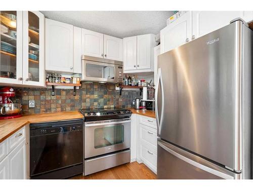 1-715 2 Avenue Nw, Calgary, AB - Indoor Photo Showing Kitchen With Stainless Steel Kitchen