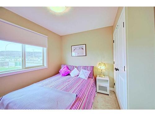 600-413 River Avenue, Cochrane, AB - Indoor Photo Showing Bedroom