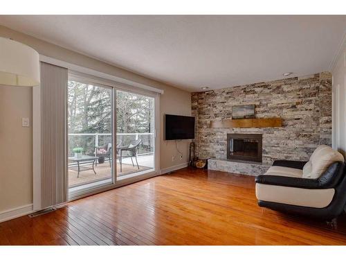 348 Pump Hill Crescent Sw, Calgary, AB - Indoor Photo Showing Living Room With Fireplace