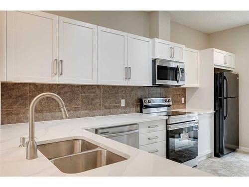 35 New Brighton Point Se, Calgary, AB - Indoor Photo Showing Kitchen With Double Sink