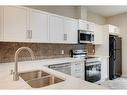 35 New Brighton Point Se, Calgary, AB  - Indoor Photo Showing Kitchen With Double Sink 