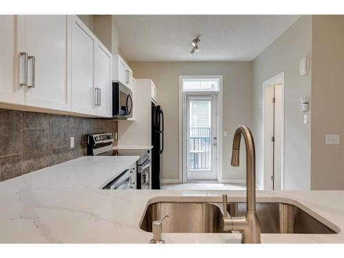 35 New Brighton Point Se, Calgary, AB - Indoor Photo Showing Kitchen With Double Sink