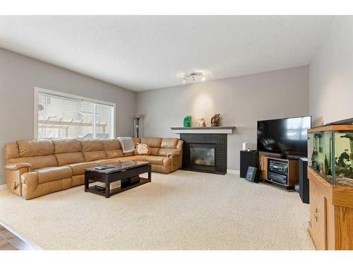 159 Panamount Circle Nw, Calgary, AB - Indoor Photo Showing Living Room With Fireplace