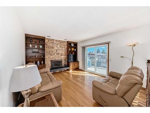 67 Edenwold Place Nw, Calgary, AB - Indoor Photo Showing Living Room With Fireplace