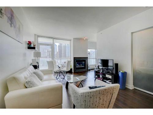 1626-222 Riverfront Avenue Sw, Calgary, AB - Indoor Photo Showing Living Room With Fireplace