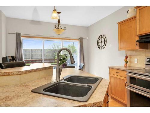 98 Chapman Close Se, Calgary, AB - Indoor Photo Showing Kitchen With Double Sink