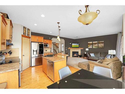 98 Chapman Close Se, Calgary, AB - Indoor Photo Showing Kitchen With Fireplace With Double Sink