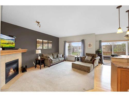 98 Chapman Close Se, Calgary, AB - Indoor Photo Showing Living Room With Fireplace