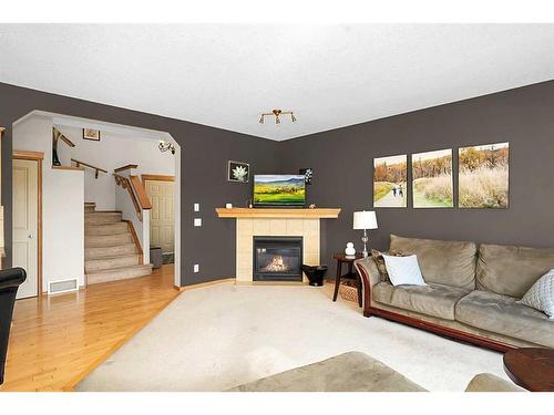 98 Chapman Close Se, Calgary, AB - Indoor Photo Showing Living Room With Fireplace