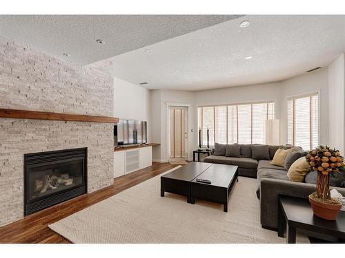 34 Discovery Rise Sw, Calgary, AB - Indoor Photo Showing Living Room With Fireplace