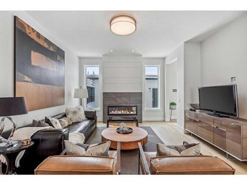 114 Valour Circle Sw, Calgary, AB - Indoor Photo Showing Living Room With Fireplace