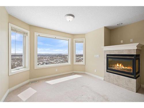 315 Rocky Ridge Drive Nw, Calgary, AB - Indoor Photo Showing Living Room With Fireplace