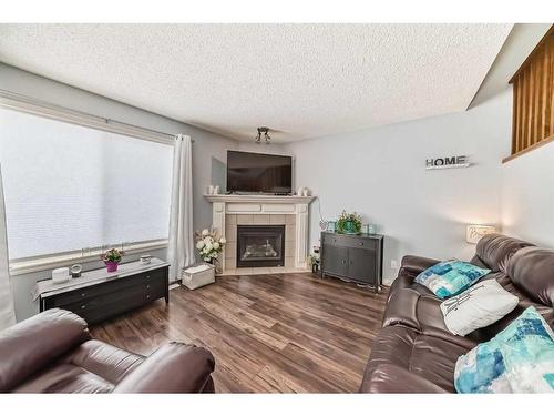 12-117 Bow Ridge Drive, Cochrane, AB - Indoor Photo Showing Living Room With Fireplace