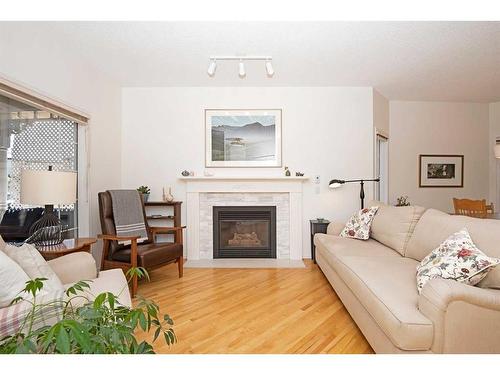 15 Cimarron Crescent, Okotoks, AB - Indoor Photo Showing Living Room With Fireplace