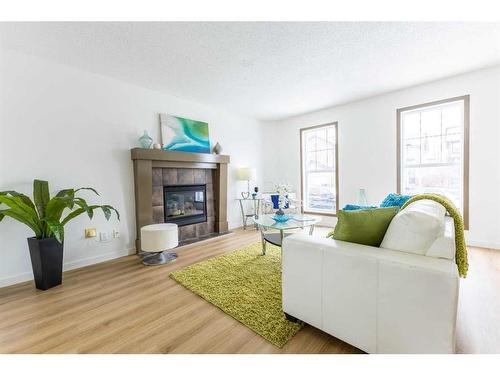 65 Silverado Saddle Avenue Sw, Calgary, AB - Indoor Photo Showing Living Room With Fireplace
