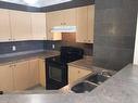 2306-12 Cimarron Common, Okotoks, AB  - Indoor Photo Showing Kitchen With Double Sink 