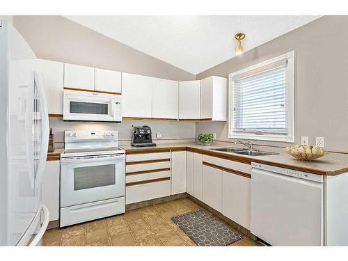 2 Rivercrest Villas Se, Calgary, AB - Indoor Photo Showing Kitchen With Double Sink