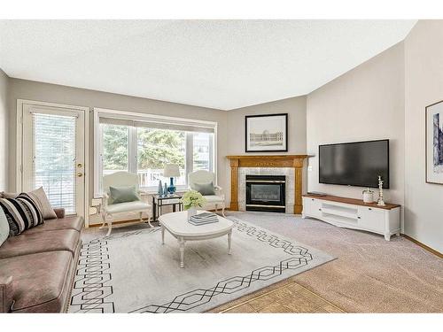 2 Rivercrest Villas Se, Calgary, AB - Indoor Photo Showing Living Room With Fireplace