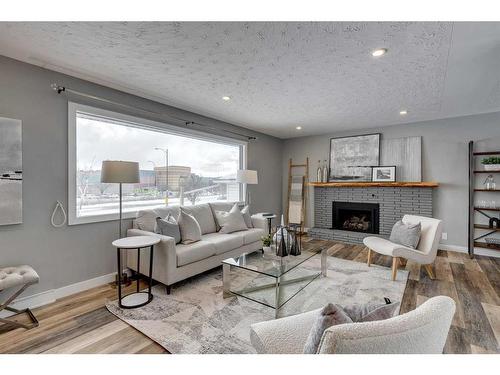 65 Meadowview Road Sw, Calgary, AB - Indoor Photo Showing Living Room With Fireplace