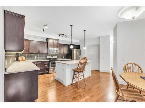 108-77 George Fox Trail, Cochrane, AB - Indoor Photo Showing Kitchen With Stainless Steel Kitchen With Upgraded Kitchen