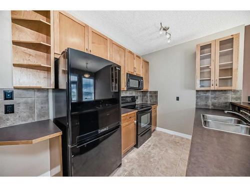 51-28 Heritage Drive, Cochrane, AB - Indoor Photo Showing Kitchen With Double Sink