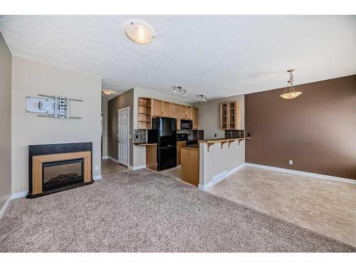 51-28 Heritage Drive, Cochrane, AB - Indoor With Fireplace