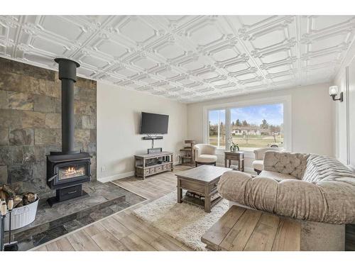 16 Macewan Place, Carstairs, AB - Indoor Photo Showing Living Room With Fireplace