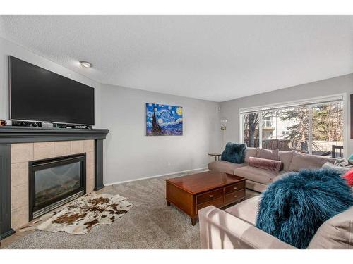 34 Springbank Rise Sw, Calgary, AB - Indoor Photo Showing Living Room With Fireplace