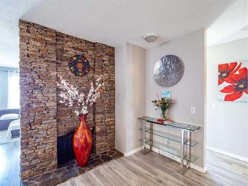 139 Manora Crescent Ne, Calgary, AB - Indoor Photo Showing Other Room With Fireplace