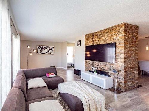 139 Manora Crescent Ne, Calgary, AB - Indoor Photo Showing Living Room With Fireplace