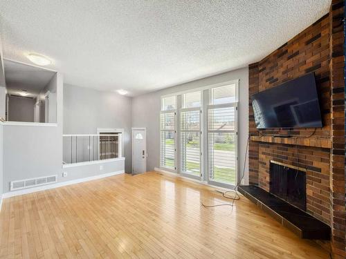 83 Lake Sylvan Close Se, Calgary, AB - Indoor Photo Showing Living Room With Fireplace