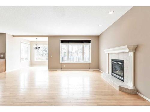 610 Rocky Ridge View Nw, Calgary, AB - Indoor Photo Showing Living Room With Fireplace